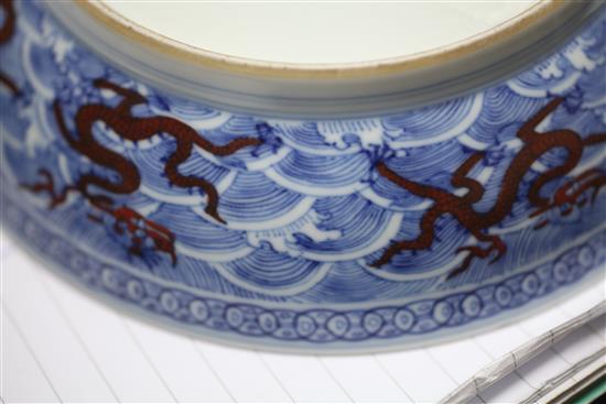 A Chinese iron red and underglaze blue dragon dish, Qianlong seal mark and of the period (1736-95), diameter 17.5cm, slight faults